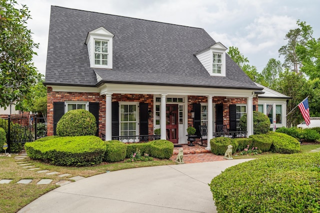 1201 Reid Rd, Augusta, GA 30909 - new england style home with fence, covered porch, and roof with shingles