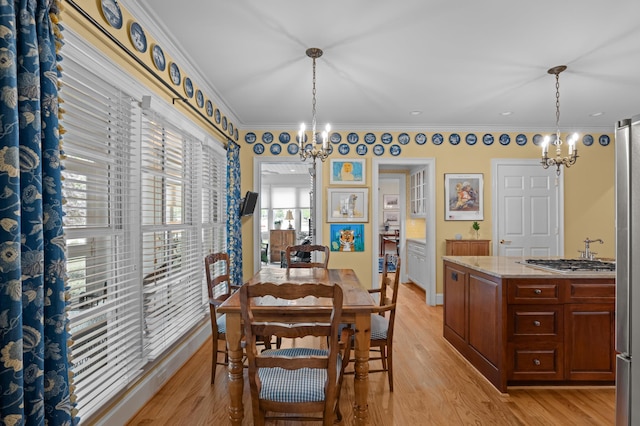 1201 Reid Rd, Augusta, GA 30909 - dining space featuring ornamental molding, a notable chandelier, and light wood-type flooring