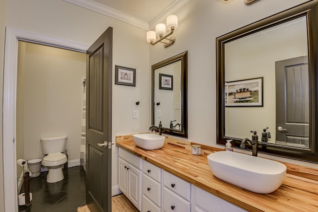 bathroom with tile patterned flooring, vanity, toilet, and crown molding