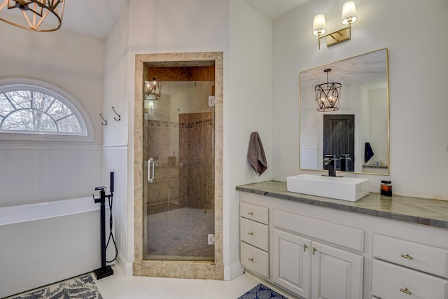 bathroom with tile patterned floors, vanity, and shower with separate bathtub