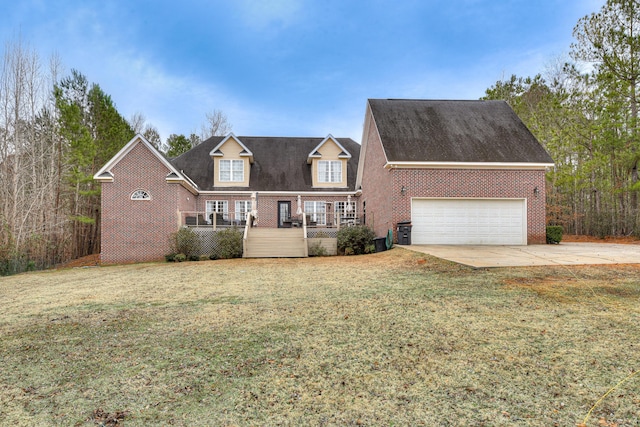 view of front of home featuring a front lawn, covered porch, and a garage