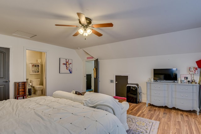 bedroom featuring connected bathroom, ceiling fan, light hardwood / wood-style flooring, and lofted ceiling