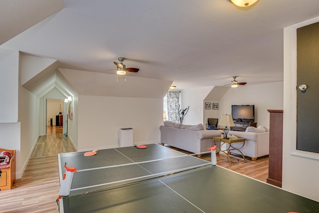 recreation room featuring light hardwood / wood-style flooring, ceiling fan, and lofted ceiling