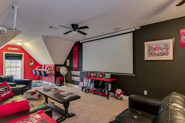 home theater room with carpet, vaulted ceiling, and ceiling fan