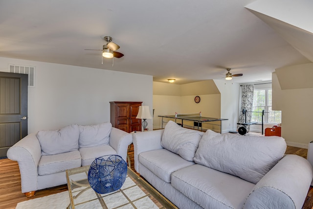 living room featuring ceiling fan and wood-type flooring