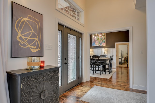 foyer with hardwood / wood-style flooring and an inviting chandelier