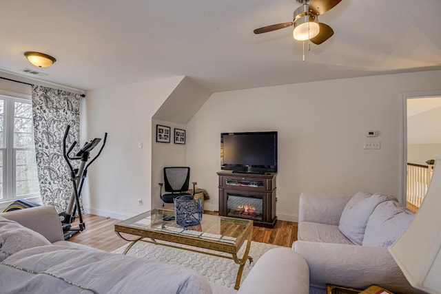 living room with light hardwood / wood-style flooring and ceiling fan