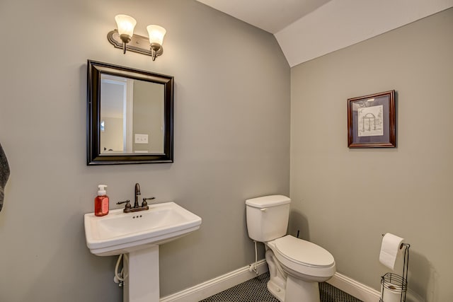 bathroom with tile patterned floors, toilet, and vaulted ceiling