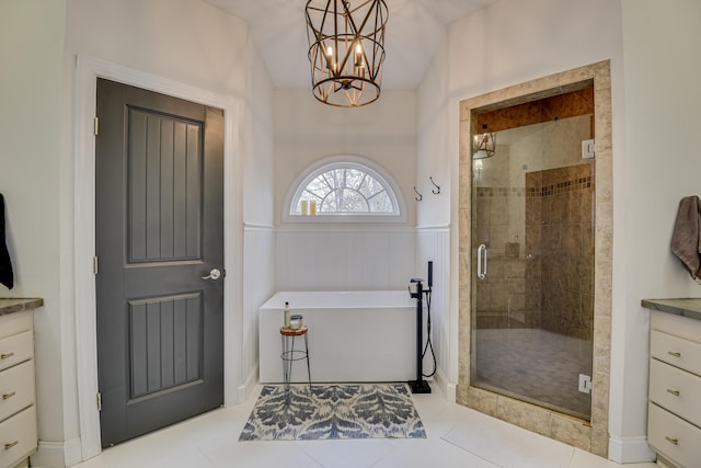 bathroom with vanity, separate shower and tub, vaulted ceiling, a chandelier, and tile patterned flooring