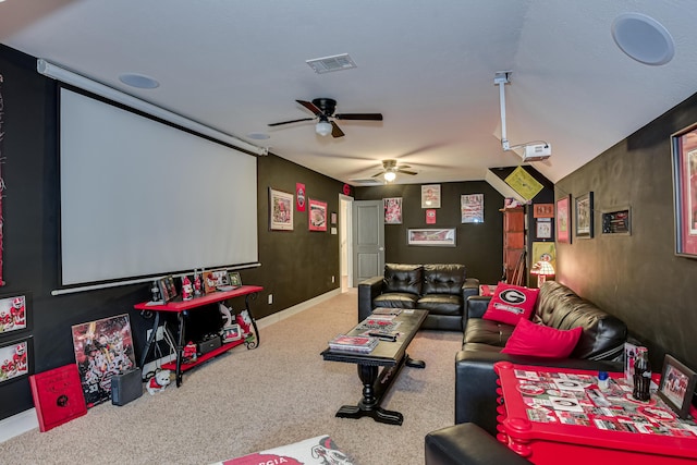 carpeted cinema room with ceiling fan