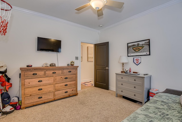 carpeted bedroom with ceiling fan and ornamental molding