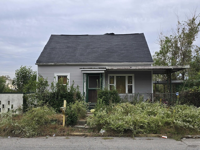 view of front of property featuring covered porch and roof with shingles