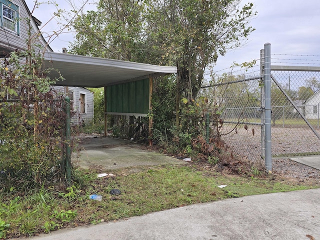 view of yard with a carport and fence