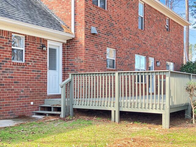 exterior space with entry steps and a lawn