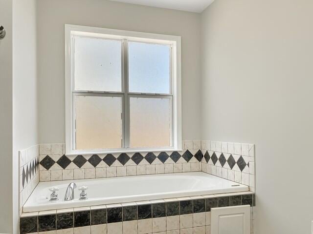 bathroom with tiled bath