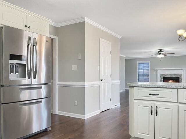 kitchen with ornamental molding, white cabinets, dark wood-style flooring, and stainless steel fridge with ice dispenser