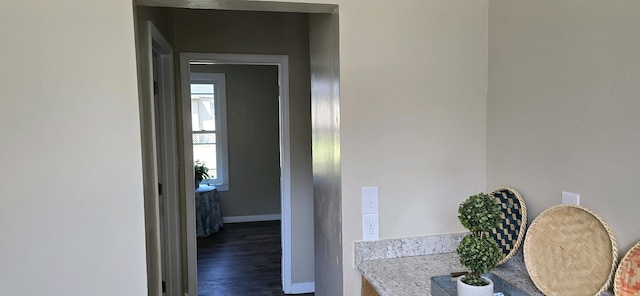 hallway with dark hardwood / wood-style floors