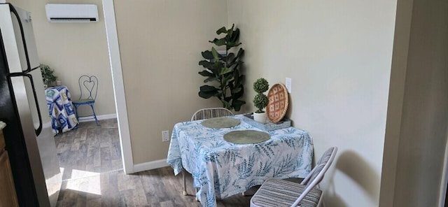 dining space featuring wood-type flooring and a wall unit AC