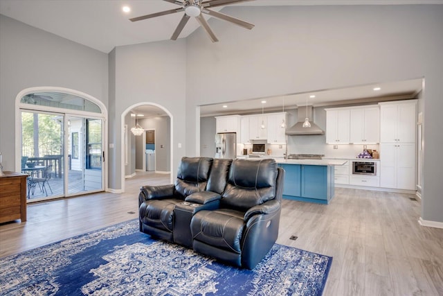 305 Kingfisher Pt, Mccormick, SC 29835 - living room featuring ceiling fan with notable chandelier, light hardwood / wood-style flooring, and high vaulted ceiling