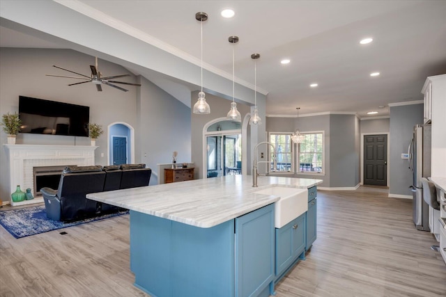 305 Kingfisher Pt, Mccormick, SC 29835 - kitchen featuring sink, blue cabinetry, white cabinetry, hanging light fixtures, and an island with sink