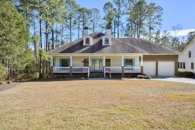 view of front of home with a porch, a garage, and a front lawn