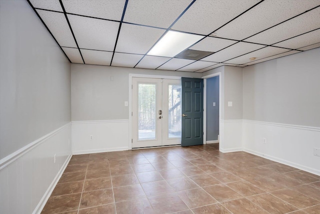 305 Kingfisher Pt, Mccormick, SC 29835 - empty room featuring tile patterned flooring, a drop ceiling, and french doors