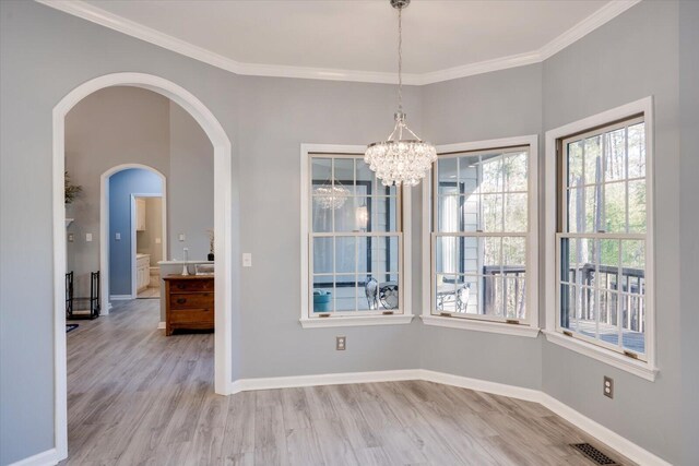305 Kingfisher Pt, Mccormick, SC 29835 - unfurnished dining area featuring crown molding, a chandelier, and light hardwood / wood-style flooring