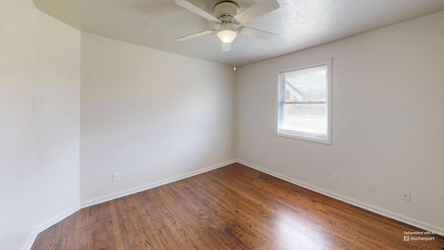 unfurnished room featuring ceiling fan, a textured ceiling, baseboards, and wood finished floors