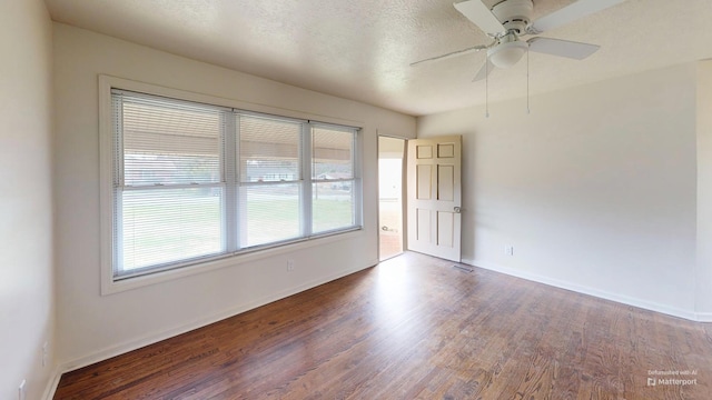 spare room featuring ceiling fan, a textured ceiling, baseboards, and wood finished floors