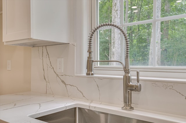 1 Bohler Ave, Evans, GA 30809 - kitchen view of white cabinets, light stone countertops, and backsplash