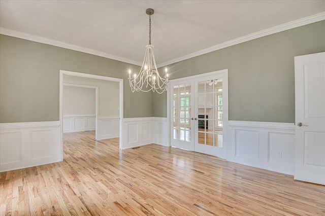 1 Bohler Ave, Evans, GA 30809 - empty room with a chandelier, a decorative wall, wood finished floors, french doors, and ornamental molding
