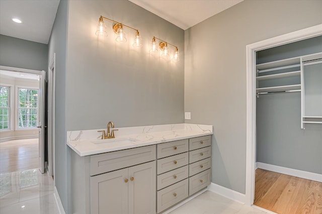 1 Bohler Ave, Evans, GA 30809 - bathroom with vanity, a walk in closet, and wood finished floors