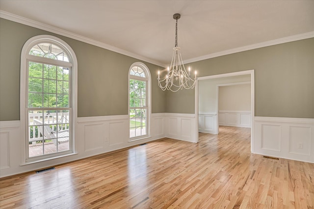1 Bohler Ave, Evans, GA 30809 - spare room featuring a chandelier, plenty of natural light, light wood-style floors, a wainscoted wall, and a decorative wall