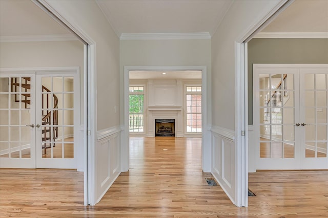 1 Bohler Ave, Evans, GA 30809 - hallway featuring french doors, crown molding, light wood finished floors, a decorative wall, and a wainscoted wall