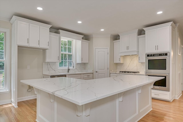 1 Bohler Ave, Evans, GA 30809 - kitchen with double oven, light wood-style flooring, recessed lighting, white cabinetry, and backsplash