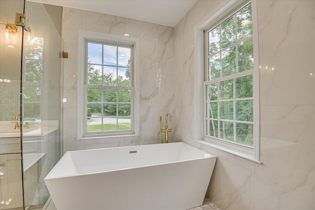 1 Bohler Ave, Evans, GA 30809 - bathroom with tile walls, a soaking tub, and vanity