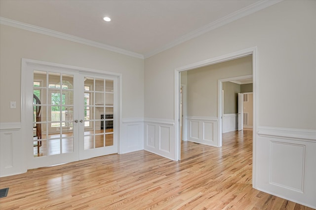 1 Bohler Ave, Evans, GA 30809 - spare room with french doors, ornamental molding, a decorative wall, light wood-style floors, and wainscoting