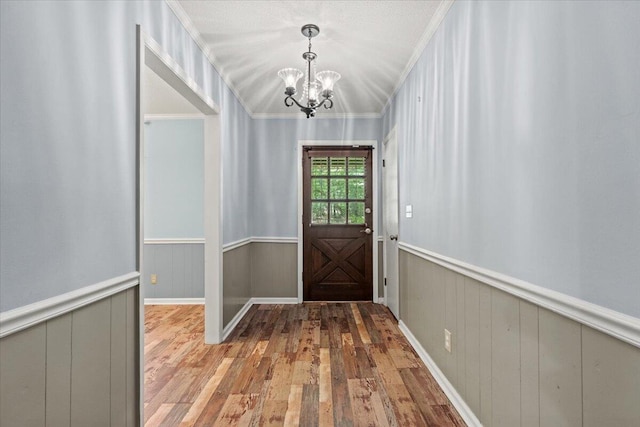 249 Usher Rd, Waynesboro, GA 30830 - entryway with a chandelier, wood finished floors, a wainscoted wall, and crown molding