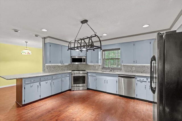 249 Usher Rd, Waynesboro, GA 30830 - kitchen featuring appliances with stainless steel finishes, a peninsula, light countertops, and recessed lighting
