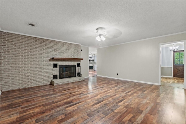 249 Usher Rd, Waynesboro, GA 30830 - unfurnished living room with wood finished floors, a textured ceiling, ceiling fan, ornamental molding, and a chandelier