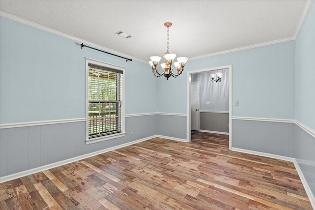 249 Usher Rd, Waynesboro, GA 30830 - empty room with a chandelier, wood finished floors, ornamental molding, and a wainscoted wall