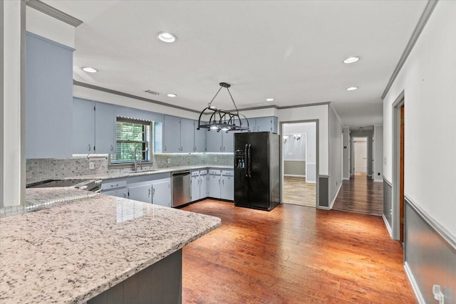 249 Usher Rd, Waynesboro, GA 30830 - kitchen featuring black fridge, stainless steel dishwasher, a chandelier, ornamental molding, and light wood-style floors