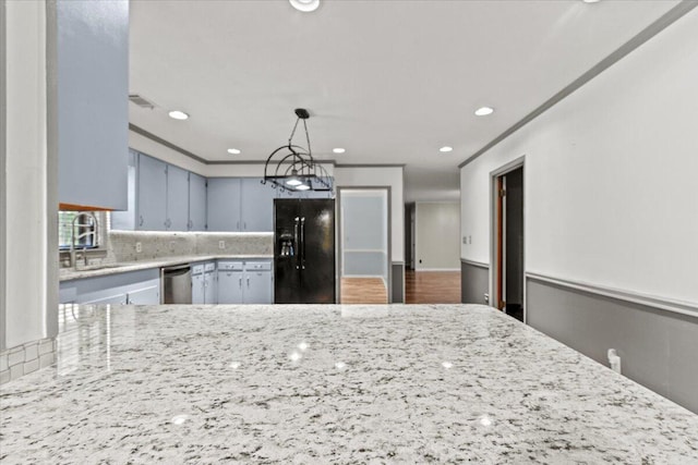 249 Usher Rd, Waynesboro, GA 30830 - kitchen with black fridge, stainless steel dishwasher, decorative backsplash, recessed lighting, and light stone counters