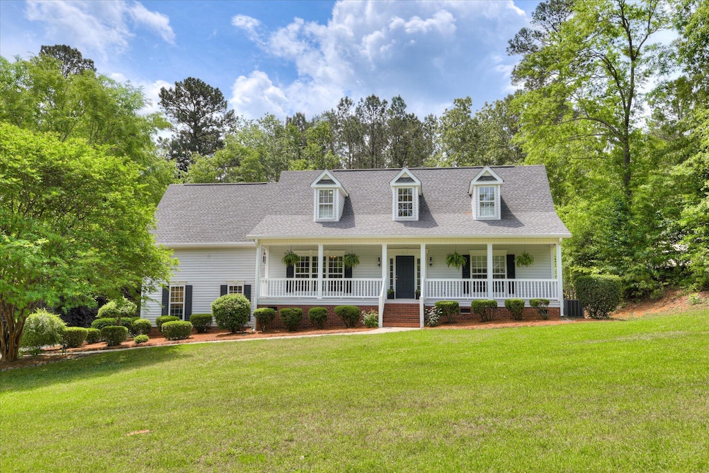 1125 Legacy Ln, Aiken, SC 29803 - new england style home featuring covered porch, a front lawn, crawl space, and view of scattered trees