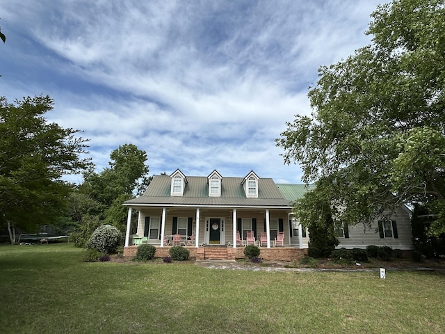 cape cod-style house with covered porch, a front lawn, and metal roof