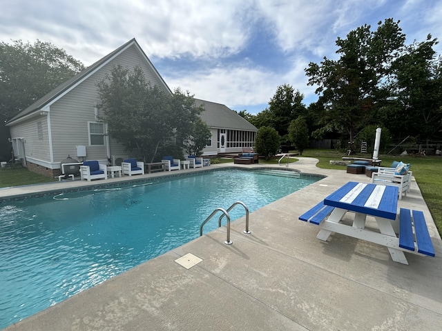 outdoor pool featuring a patio, outdoor lounge area, and a yard