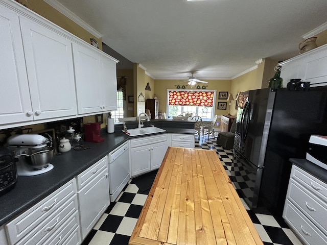 kitchen with a sink, dishwasher, dark flooring, ceiling fan, and butcher block countertops