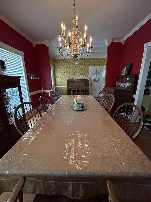 dining room with a chandelier, wood finished floors, and crown molding
