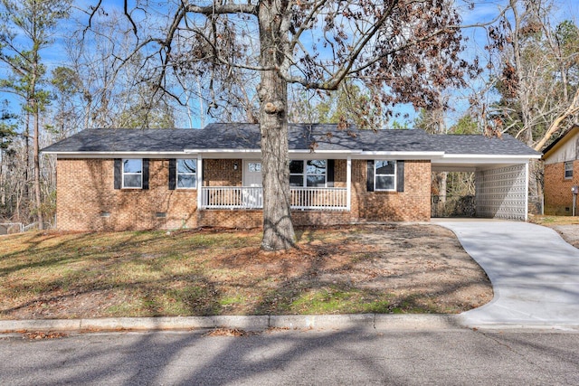 single story home with a front yard, a porch, and a carport