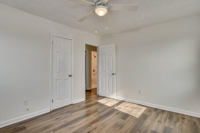 unfurnished room with hardwood / wood-style floors, a textured ceiling, and ceiling fan